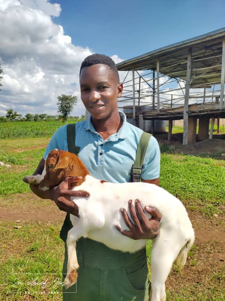 Farmer David holding a farm goat